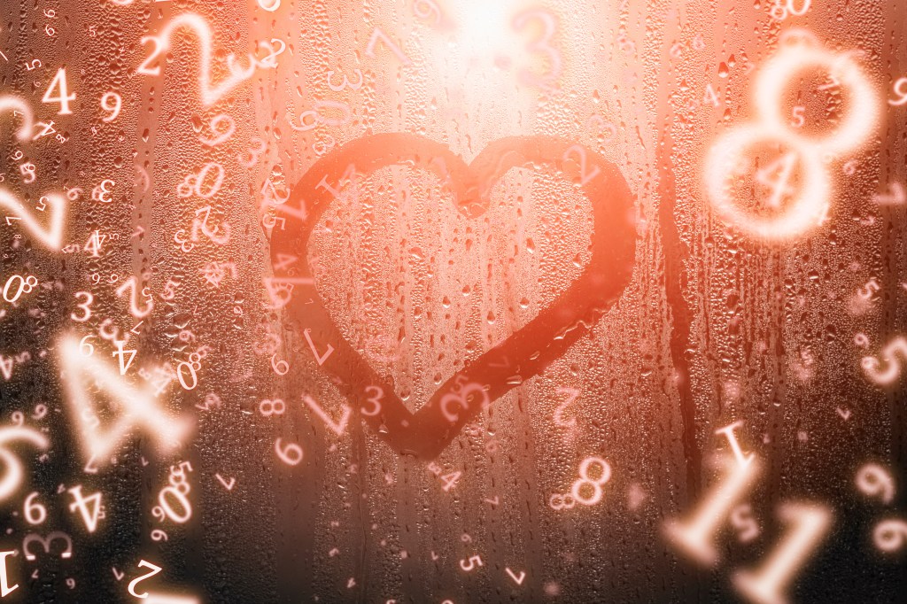 A foggy glass surface with a heart shape drawn in the condensation, surrounded by floating numbers.